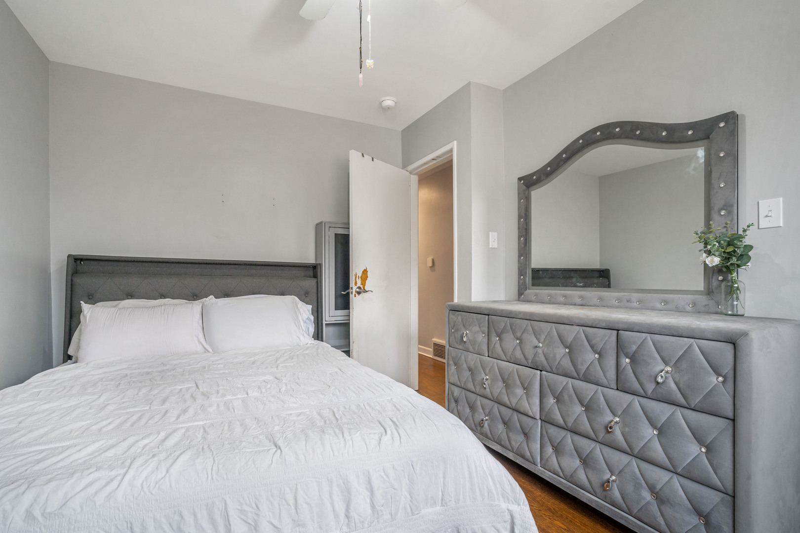 129 Rice Avenue Bellwood, IL 60104 - Photo 12 of 23 a bedroom with a large bed and a potted plant