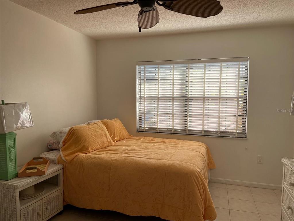 23465 Harbor View Road, Unit 1006 Punta Gorda, FL 33980 - Photo 17 of 36 a bedroom with a bed and a window