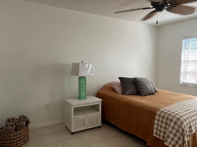 23465 Harbor View Road, Unit 1006 Punta Gorda, FL 33980 - Photo 19 of 36 a bedroom with a bed and a chandelier
