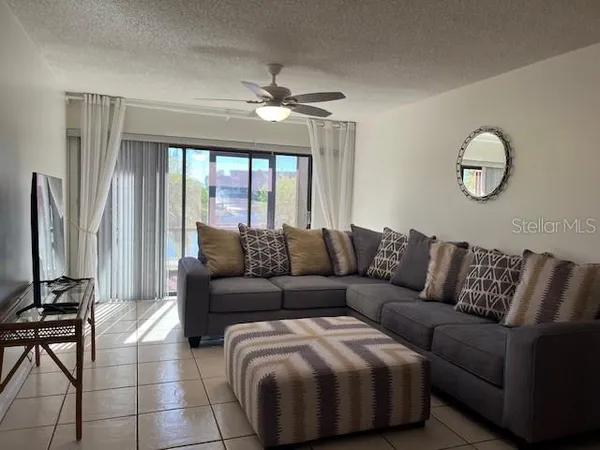 a living room with furniture and a large window