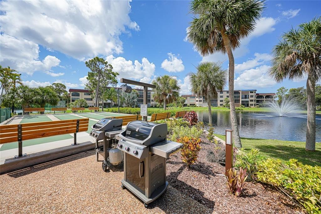 23465 Harbor View Road, Unit 1006 Punta Gorda, FL 33980 - Photo 31 of 36 a view of a lake with couches in the patio