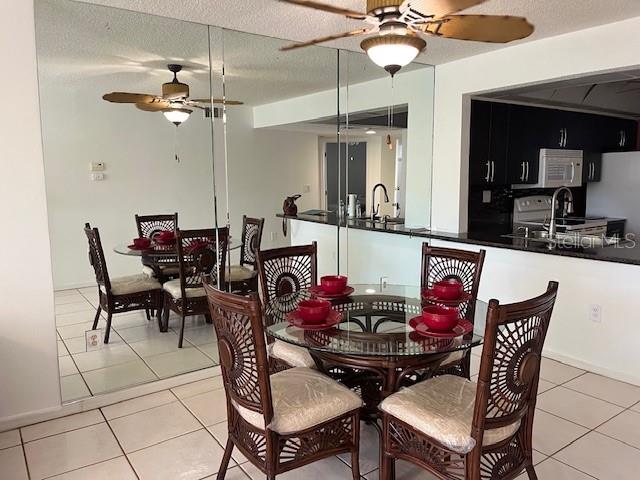 23465 Harbor View Road, Unit 1006 Punta Gorda, FL 33980 - Photo 10 of 36 a view of a dining room with furniture and chandelier