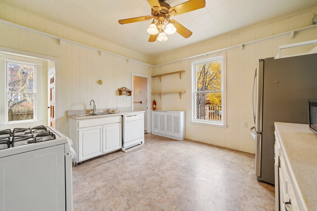 151 Lincoln Street Holyoke, MA 01040 - Photo 13 of 40 a kitchen with a refrigerator and white cabinets