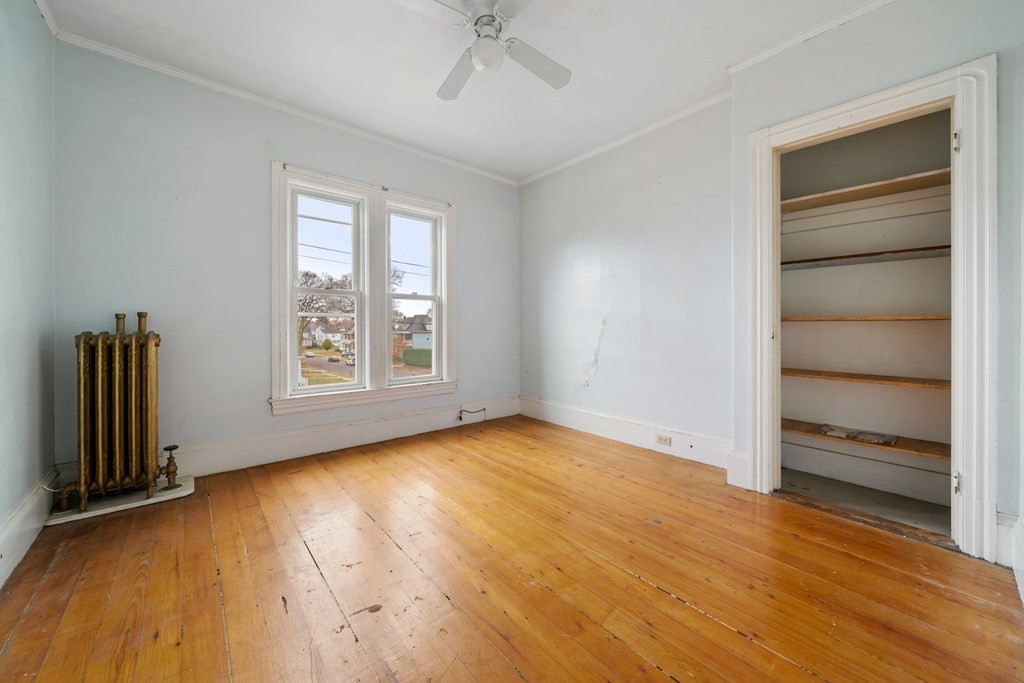 151 Lincoln Street Holyoke, MA 01040 - Photo 15 of 40 a view of an empty room with a window and wooden floor