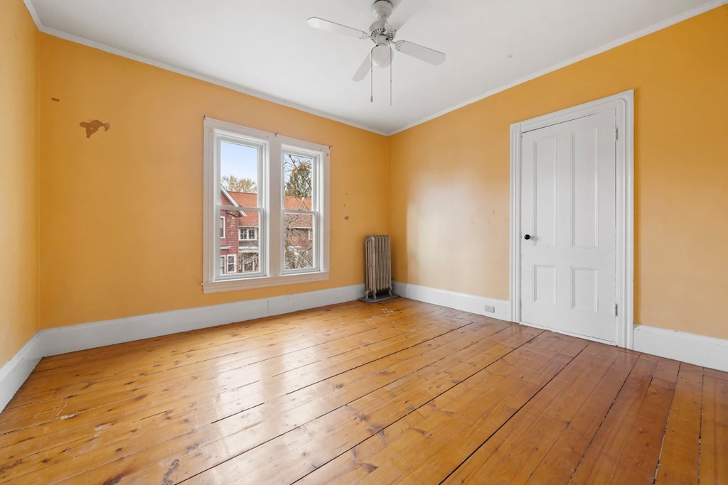 151 Lincoln Street Holyoke, MA 01040 - Photo 17 of 40 a view of an empty room with window and wooden floor