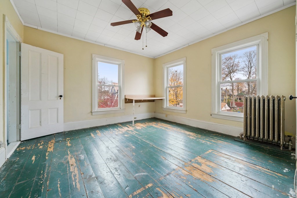 151 Lincoln Street Holyoke, MA 01040 - Photo 23 of 40 a view of an empty room with a window and wooden floor