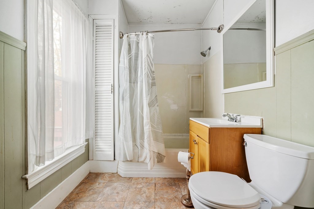 151 Lincoln Street Holyoke, MA 01040 - Photo 26 of 40 a white toilet sitting next to a bathroom sink