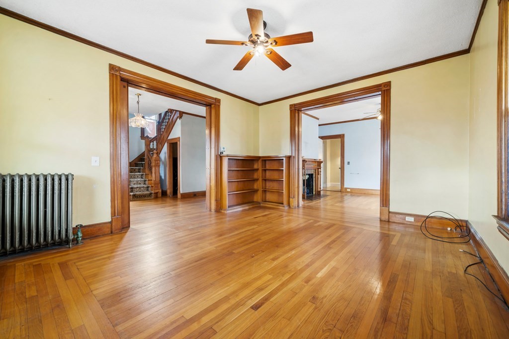 151 Lincoln Street Holyoke, MA 01040 - Photo 4 of 40 a view of a livingroom with wooden floor and a ceiling fan