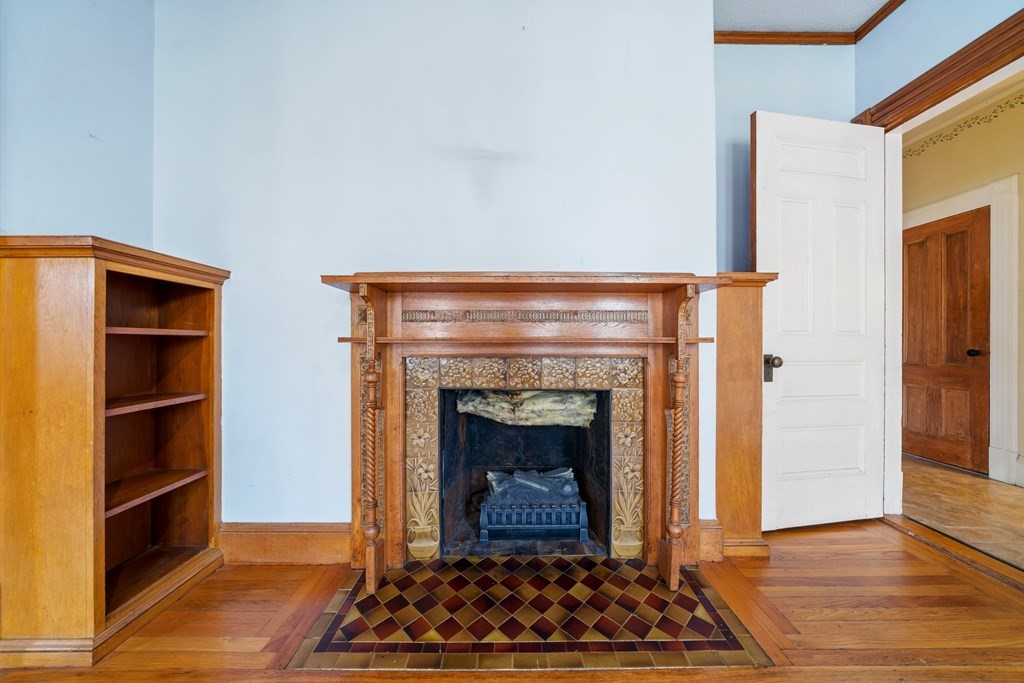 151 Lincoln Street Holyoke, MA 01040 - Photo 5 of 40 a living room with a fireplace and a walk in closet