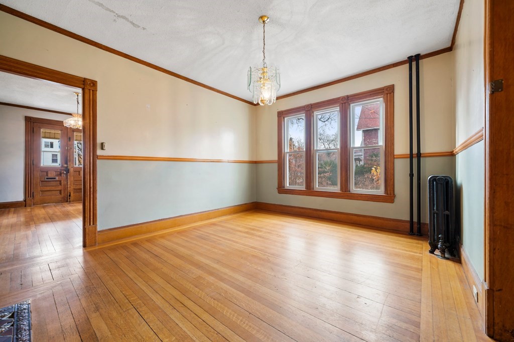 151 Lincoln Street Holyoke, MA 01040 - Photo 8 of 40 a view of an empty room with window and wooden floor