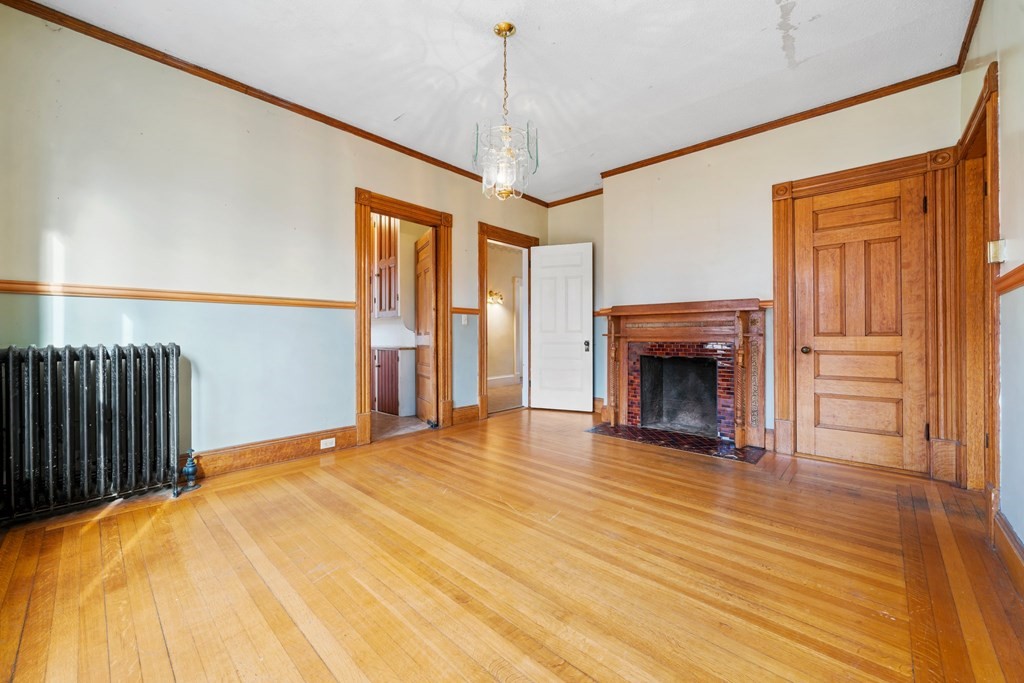 151 Lincoln Street Holyoke, MA 01040 - Photo 10 of 40 a view of livingroom with fireplace cabinet and window
