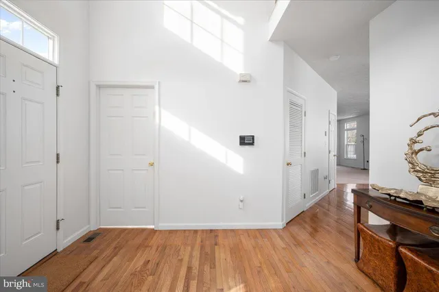 a large kitchen with stainless steel appliances granite countertop a stove a sink dishwasher and a refrigerator with wooden floor