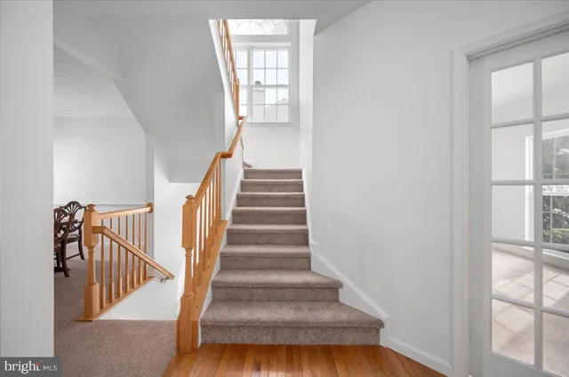 a kitchen with stainless steel appliances granite countertop a sink dishwasher stove and refrigerator with wooden floor