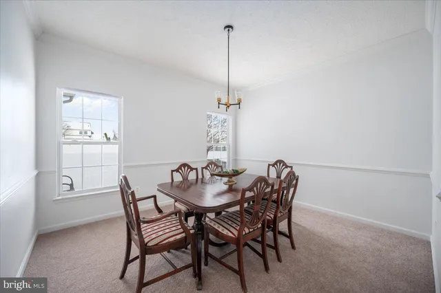 a large kitchen with stainless steel appliances granite countertop a stove a refrigerator and a wooden cabinets