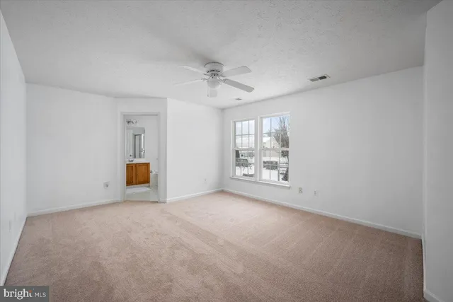 a view of an empty room and a window