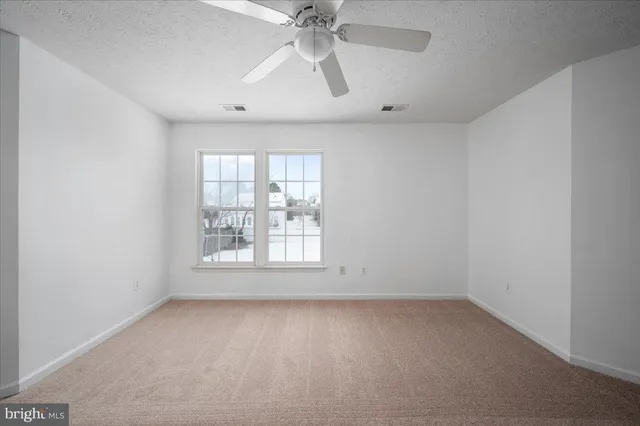 a view of a building with floor to ceiling windows and a basket ball poll