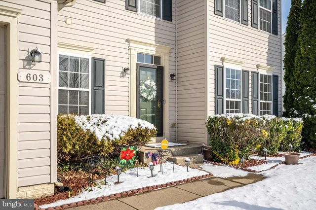a view of a patio with a table and chairs under an umbrella
