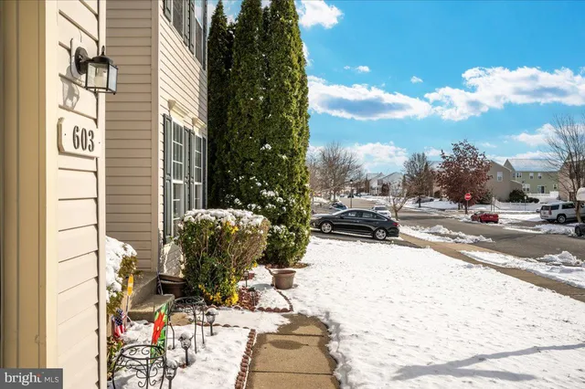 a view of a terrace with couches and wooden fence