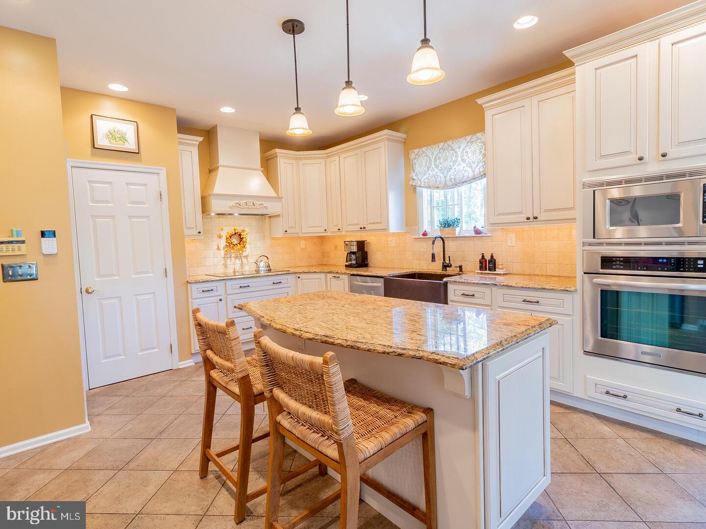 63 Emerald Ridge Drive Bear, DE 19701 - Photo 13 of 78 a kitchen with stainless steel appliances kitchen island granite countertop a sink a stove and a refrigerator