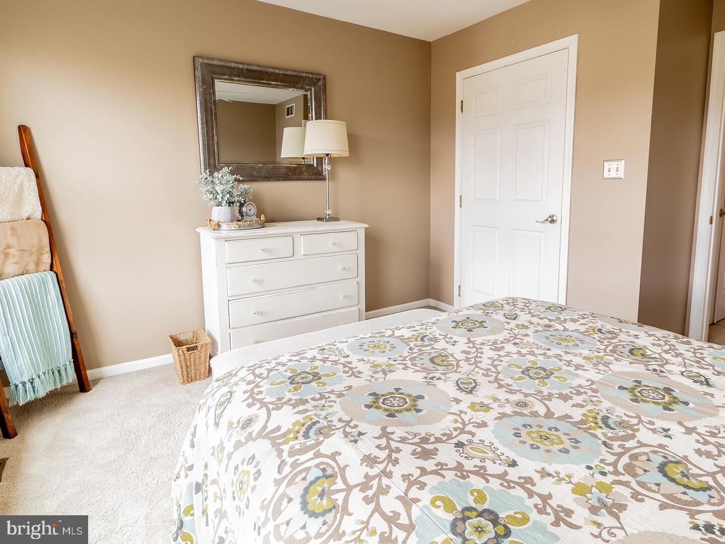 63 Emerald Ridge Drive Bear, DE 19701 - Photo 46 of 78 a bedroom with a bed and a mirror on dresser