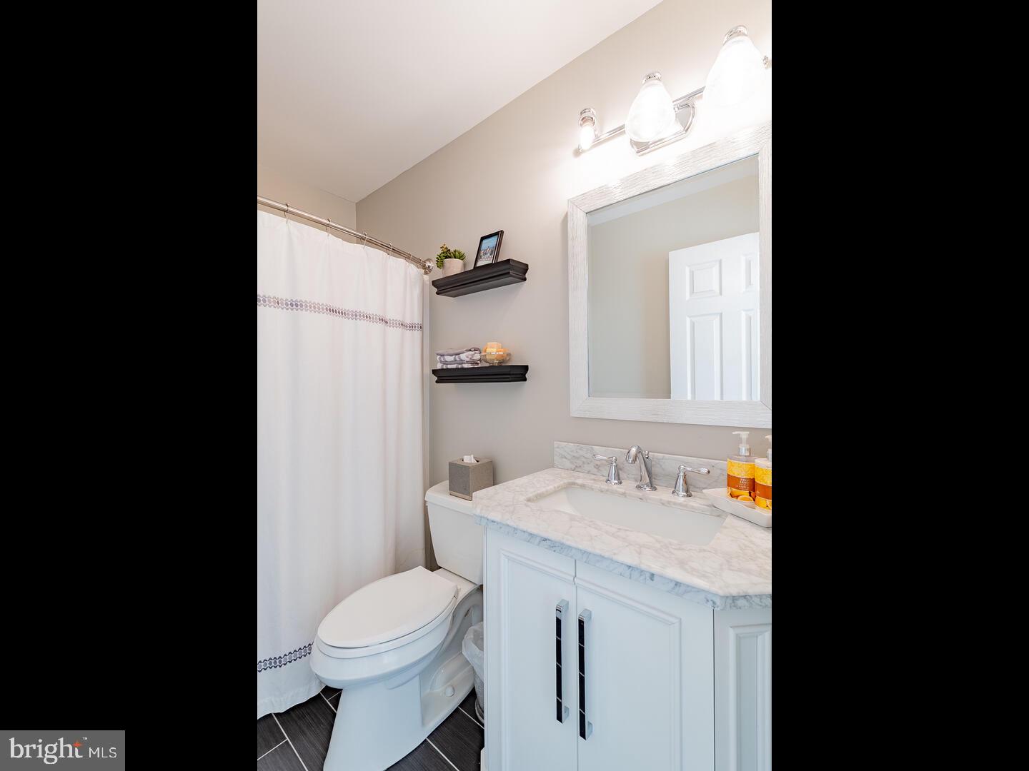 63 Emerald Ridge Drive Bear, DE 19701 - Photo 51 of 78 a bathroom with a sink toilet mirror and vanity