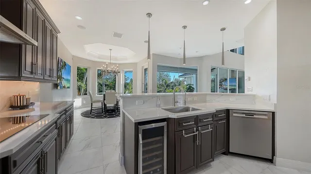 a kitchen with stainless steel appliances kitchen island granite countertop a sink and a stove