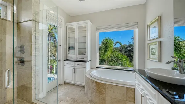 a spacious bedroom with a bed and a chandelier