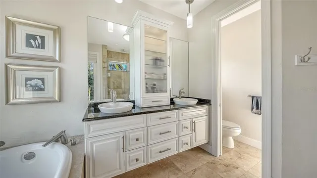 a bathroom with a granite countertop sink a mirror and a shower