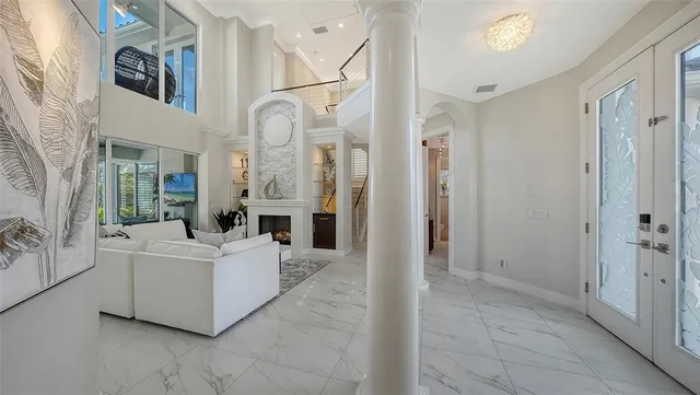a living room with furniture a fireplace and a floor to ceiling window