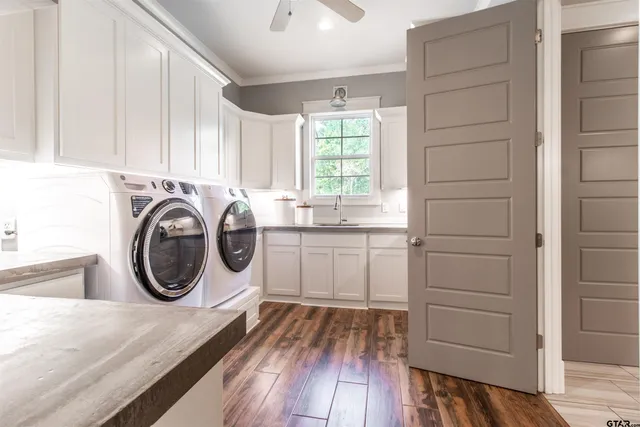 a bathroom with a sink a toilet a mirror and shower
