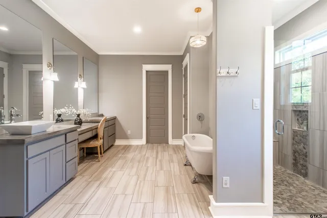 a spacious bedroom with a bed and a flat screen tv