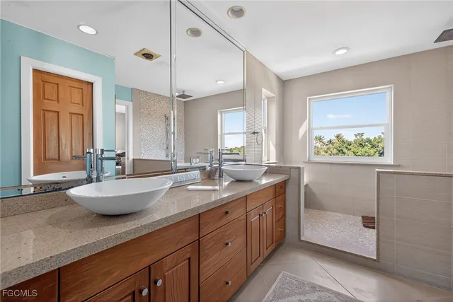 a spacious bathroom with a granite countertop sink mirror and double