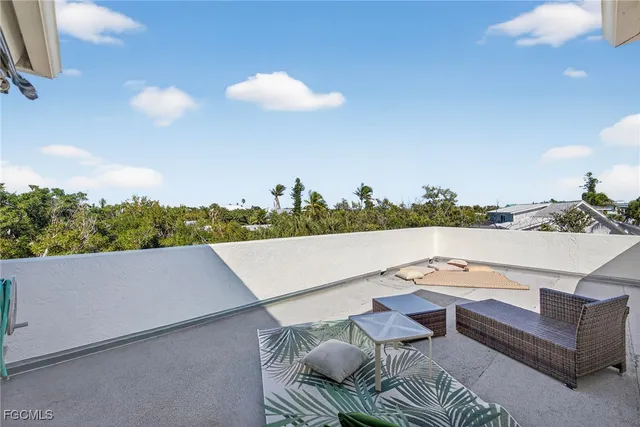 a bedroom with a bed a chair and painting on the wall