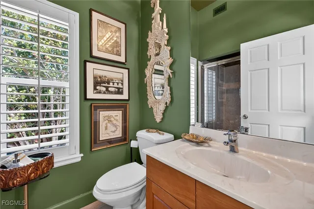 a bedroom with a large bed and windows