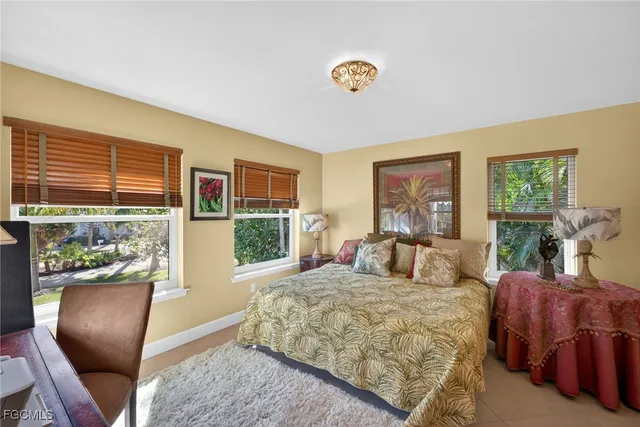 a bathroom with a sink a toilet a mirror a vanity a bathtub and shower