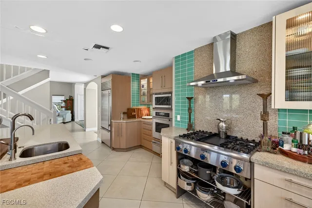 a kitchen with a stove a sink and a refrigerator