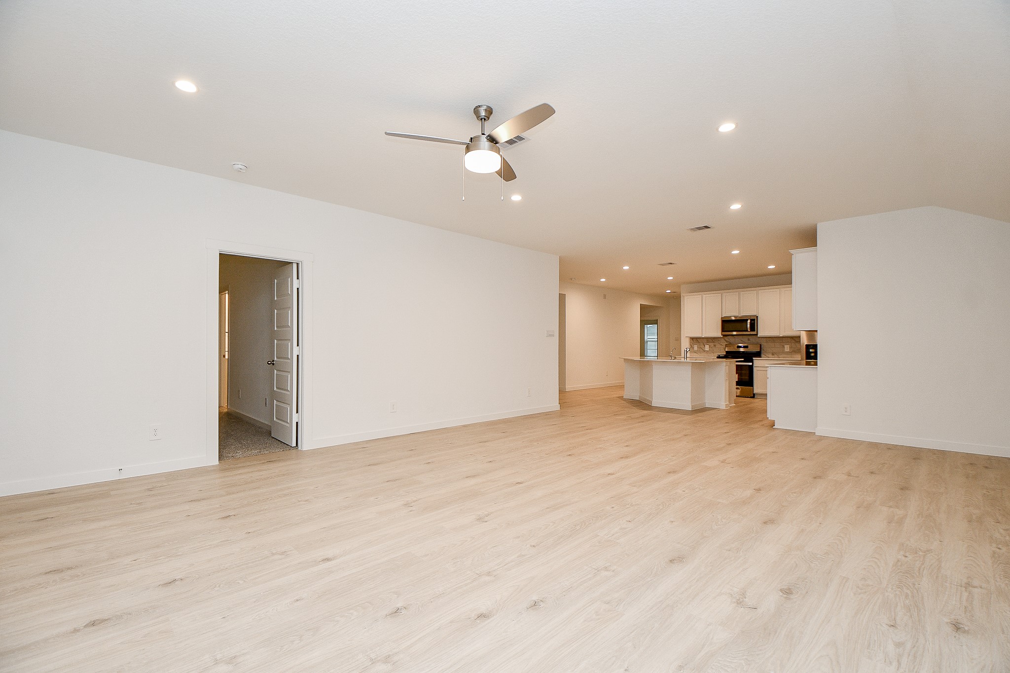 31715 Hallington Hl Lane Fulshear, TX 77441 - Photo 11 of 37 a view of a kitchen with a sink and a refrigerator