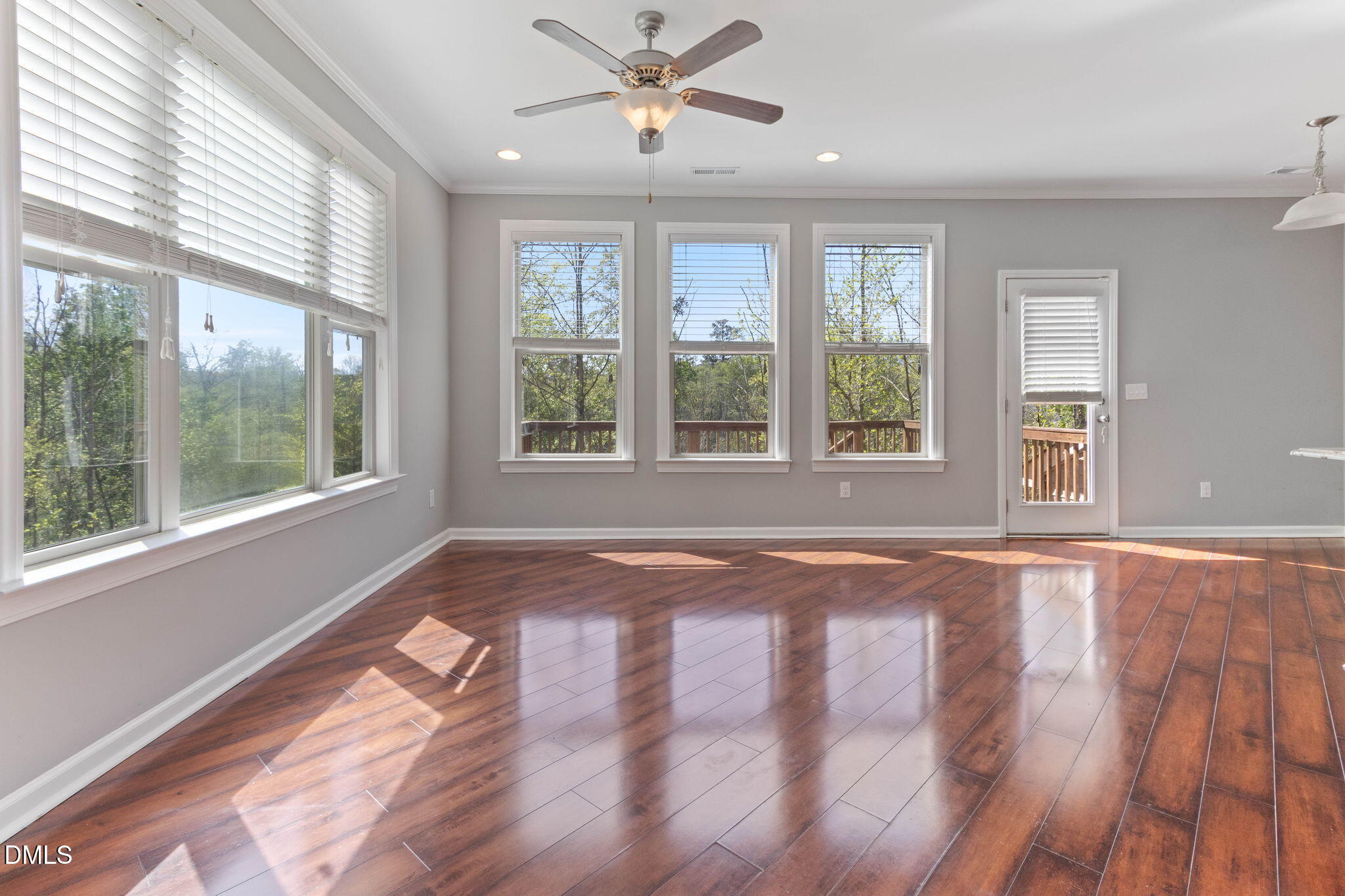 14303 Foxcroft Road Raleigh, NC 27614 - Photo 12 of 70 a view of an empty room with a window and wooden floor