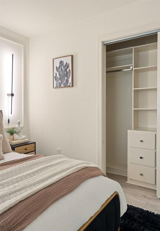 6003 Jain Lane, Unit A Austin, TX 78721 - Photo 13 of 15 a bedroom with a bed and a cabinets