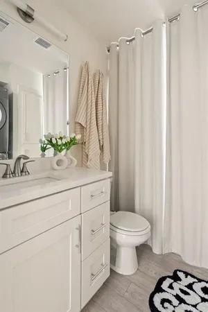 a bathroom with a sink a toilet and a mirror