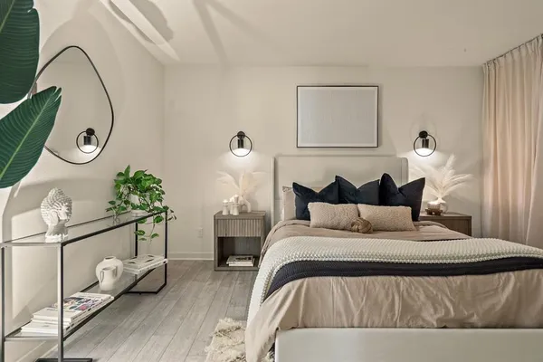 a bedroom with bed and a chandelier
