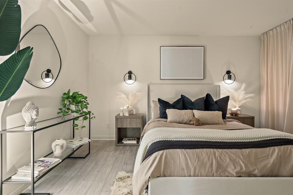 6003 Jain Lane, Unit A Austin, TX 78721 - Photo 4 of 15 a bedroom with bed and a chandelier