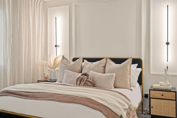 a large white bed in a white room
