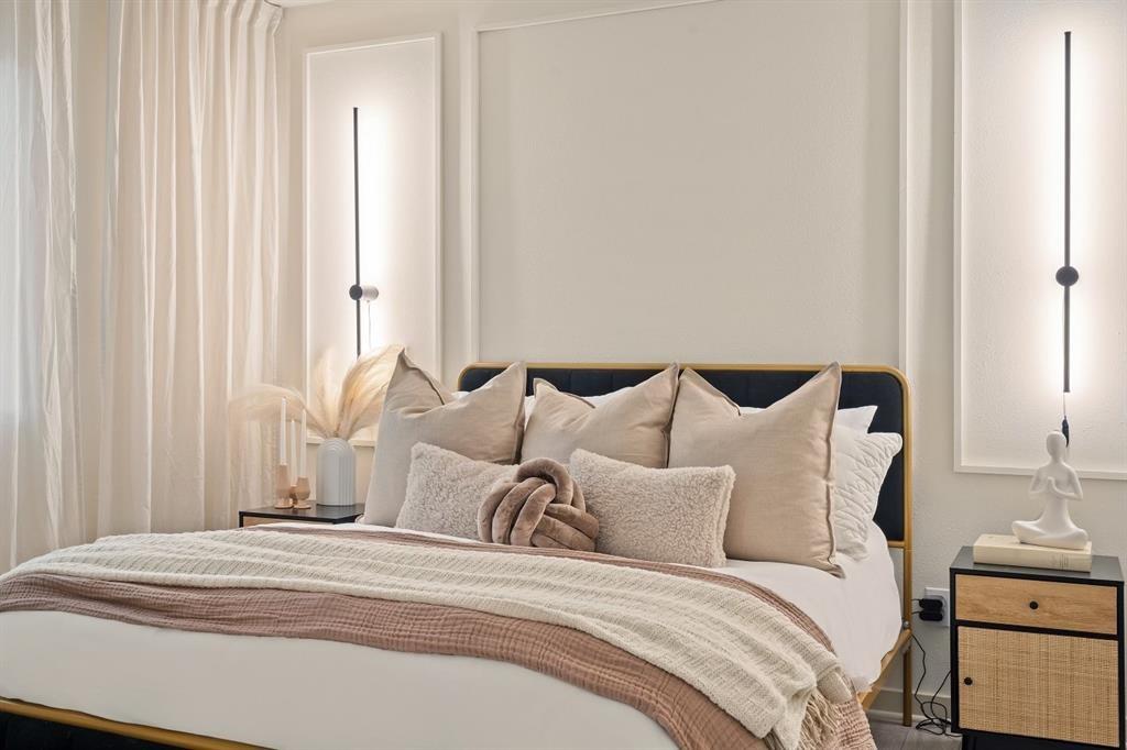 6003 Jain Lane, Unit A Austin, TX 78721 - Photo 5 of 15 a large white bed in a white room