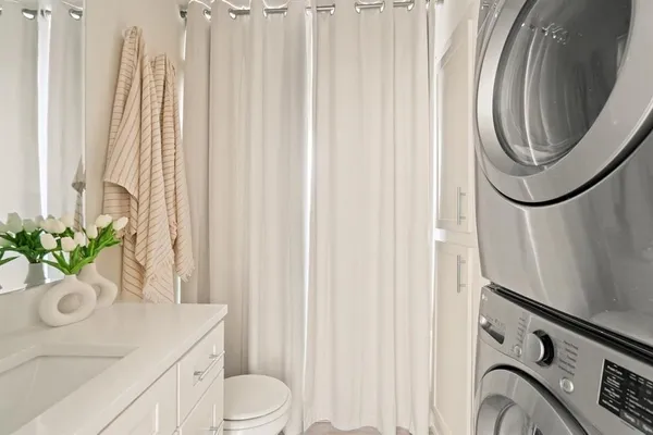 a bathroom with a sink a toilet and a mirror