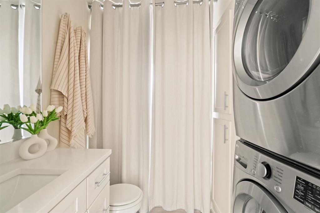 6003 Jain Lane, Unit A Austin, TX 78721 - Photo 6 of 15 a bathroom with a sink a toilet and a mirror