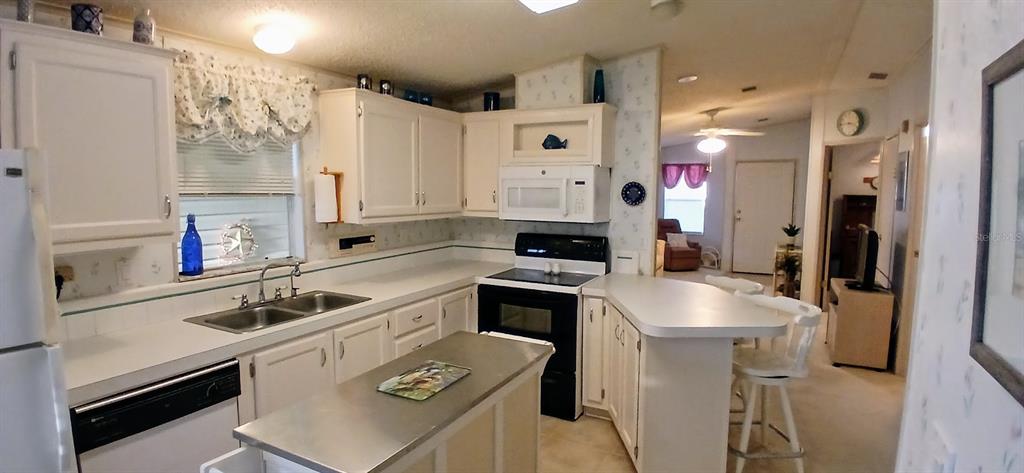 278 Pine Loop Frostproof, FL 33843 - Photo 13 of 40 a kitchen that has a sink cabinets counter space and appliances