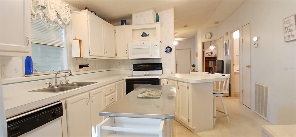 278 Pine Loop Frostproof, FL 33843 - Photo 18 of 40 a kitchen with a sink stove and cabinets