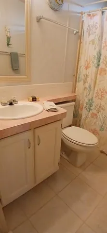 a bathroom with a sink toilet and mirror
