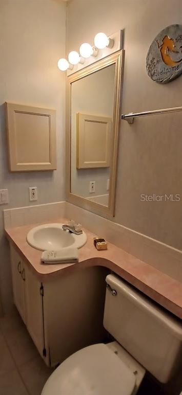 278 Pine Loop Frostproof, FL 33843 - Photo 22 of 40 a bathroom with a sink toilet and mirror
